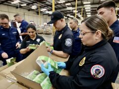 CBP and FDA officers inspect seized vape products during Operation Red Mist