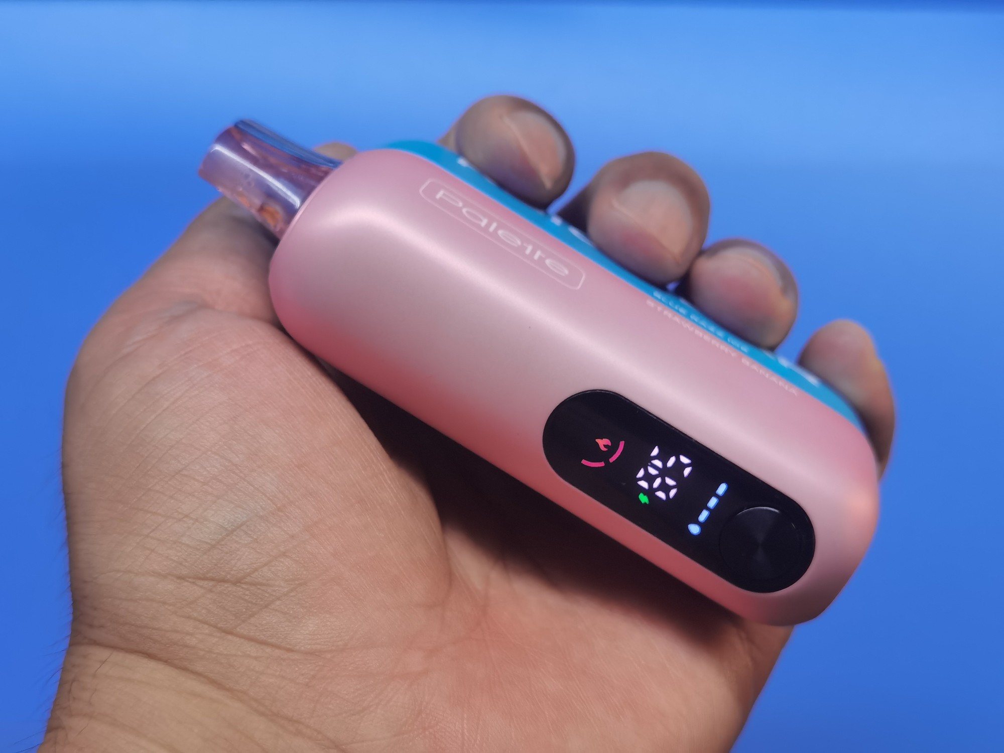 Hands-on close-up of the REIGN BAR Palette battery liquid and power display