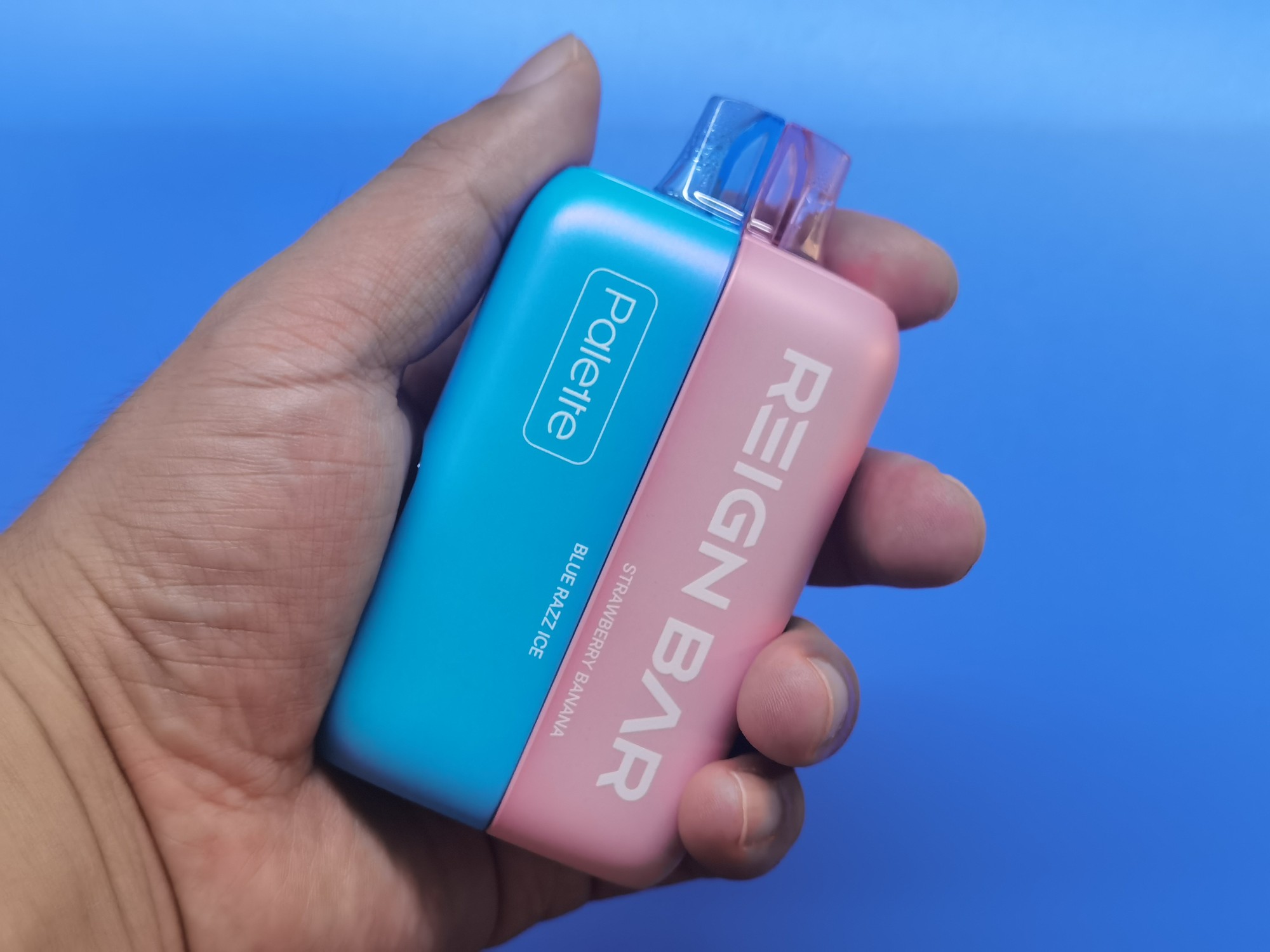 Hands-on photo of blue and pink REIGN BAR Palette halves joined in Snap mode
